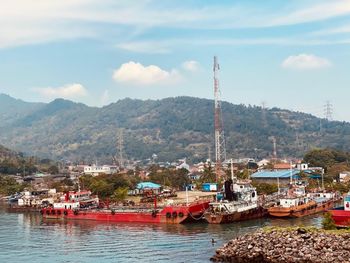 Some freight ships lean on the pier located in a quiet and cool mountain area