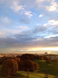 View of cityscape against cloudy sky