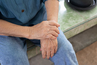 Midsection of woman holding hands