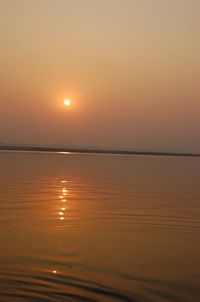 Scenic view of sea against orange sky