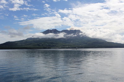 Scenic view of sea and mountains against sky