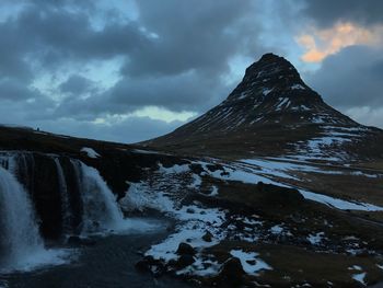 Scenic view of waterfall against sky during winter