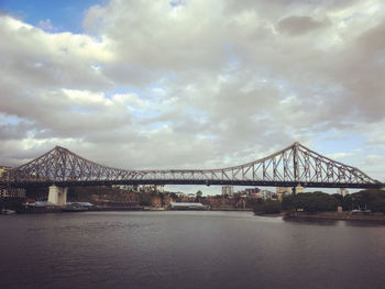 View of bridge over sea against cloudy sky