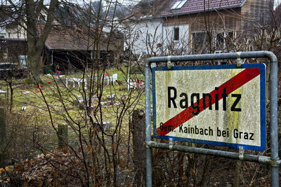 Close-up of road sign against bare trees