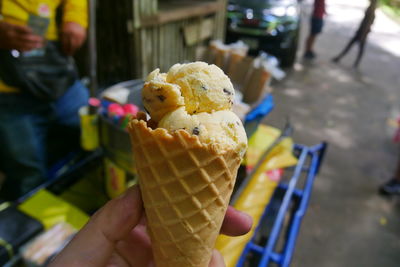 Close-up of hand holding ice cream cone