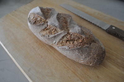 High angle view of bread and knife on cutting board