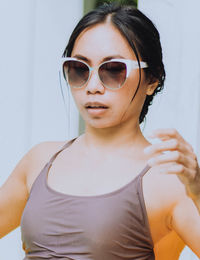 Portrait of young woman wearing sunglasses