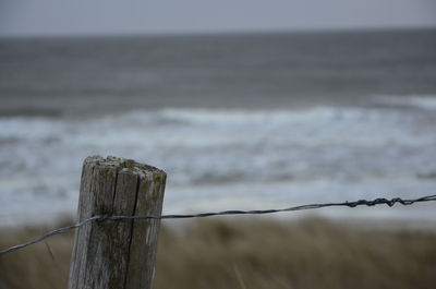 Close-up of barbed wire on beach