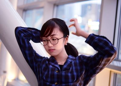 Portrait of young woman wearing eyeglasses