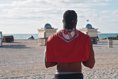 Rear view of man standing on beach