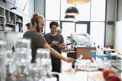 Happy colleagues working together in cafe