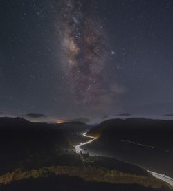 Scenic view of mountain against sky at night