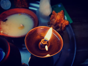 High angle view of lit candles on table