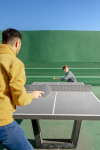 Father and son playing table tennis