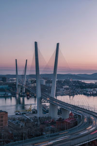 Bridge over river against sky during sunset