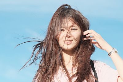 Portrait of girl against sky