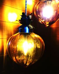 Low angle view of illuminated lamp at home