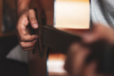 The human hand playing the guitar