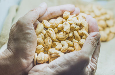 Cashew nuts in hand. healthy fats and protein food agriculture industry.