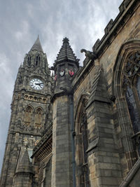 Low angle view of clock tower against sky in city