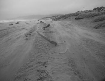 Frozen beach against sky during winter