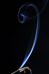 Close-up of blue light over black background