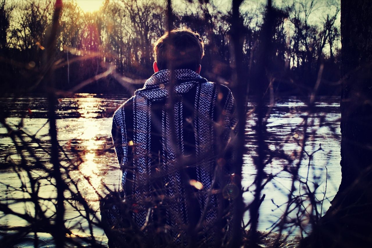 water, lifestyles, leisure activity, tree, reflection, rear view, men, standing, lake, silhouette, sunlight, person, outdoors, nature, sitting, three quarter length, togetherness