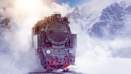 Panoramic view of train against sky during winter