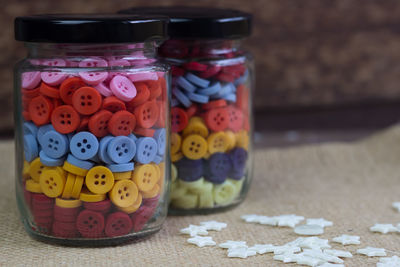 Close-up of multi colored glass jar on table