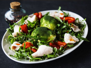 Benedict with salad and chicken fillet on the table