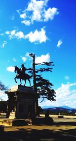 Low angle view of statue against cloudy sky