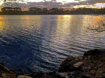 Scenic view of lake against sky at sunset