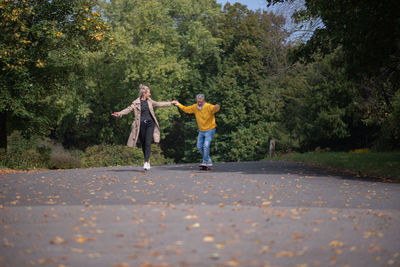 Rear view of woman walking on road