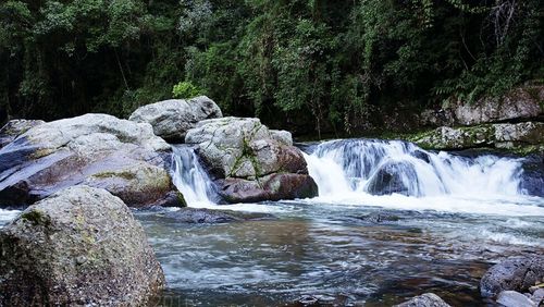 Scenic view of river flowing through rocks