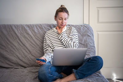 Young man using laptop at home