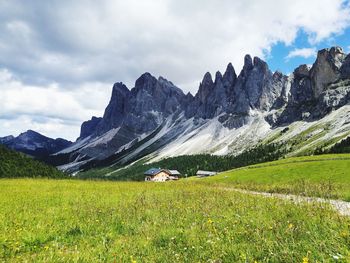 Scenic view of field and mountains against sky