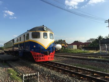 Train on railroad tracks against sky