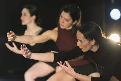 Young female contemporary dancers practicing in studio