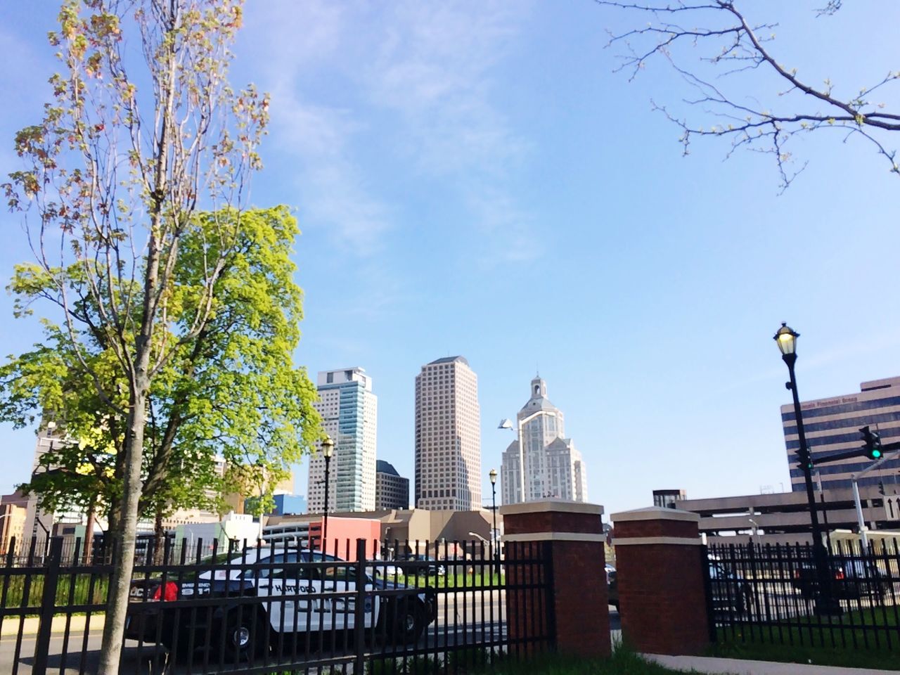 architecture, built structure, building exterior, day, skyscraper, low angle view, outdoors, sky, tree, city, no people, clear sky, modern