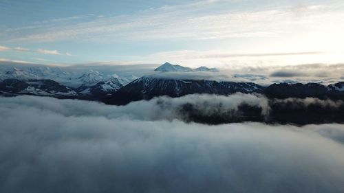 Scenic view of snow covered mountains against sky