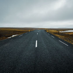 Road passing through landscape against sky