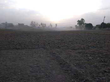 Scenic view of field against sky at foggy weather