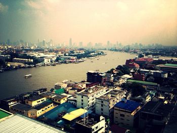 View of cityscape with river in foreground