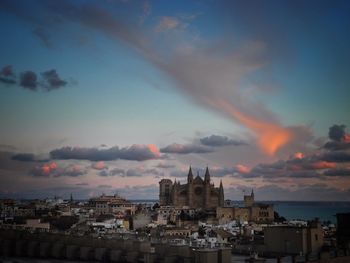 Palma cathedral in city against sky at dusk