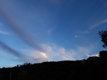 Silhouette landscape against blue sky