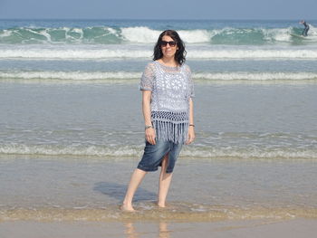 Full length of woman standing on beach