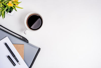 Directly above shot of coffee cup over white background