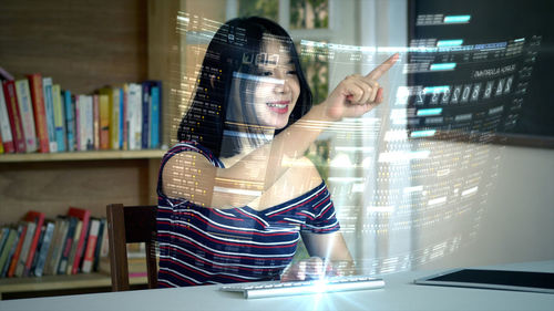 Midsection of woman using smart phone on table