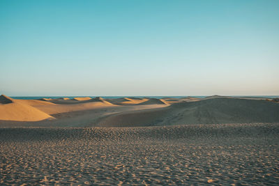 Scenic view of desert against clear sky