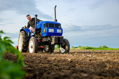 A farmer on a tractor works the field. milling soil, crushing and loosening ground